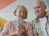 Elderly couple looking at a smartphone together on phone