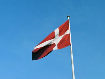 a red and white flag on a flagpole